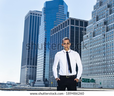 Portrait of Businessman. Dressing in a white shirt, a black necktie, pants, two hands putting in pockets, a young guy is standing in the front of a corporation building, confidently looking forward.