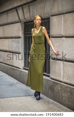Girl Waiting For You. Dressing in a green, long Maxi Tank Dress,  black dress sandals, a young black woman is standing by old fashion style window and wall, passionately looking forward.