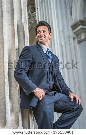 Man waiting for you. Dressing in dark blue suit, necktie, a handsome, sexy, middle age businessman is standing outside office, smiling, relaxing.
