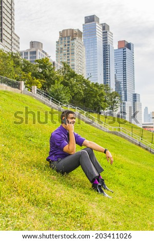 Young Man on the phone. Dressing in a purple shirt, gray pants, a black tie, leather shoes, a young handsome businessman is sitting outside a business district, making a call on a mobile phone.