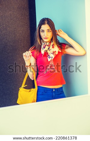 Woman Waiting for You. Wearing red short sleeve shirt, light weight scarf, blue pants, arm carrying a yellow leather hand bag, a beautiful lady standing in modern interior, thinking, lost in thought.