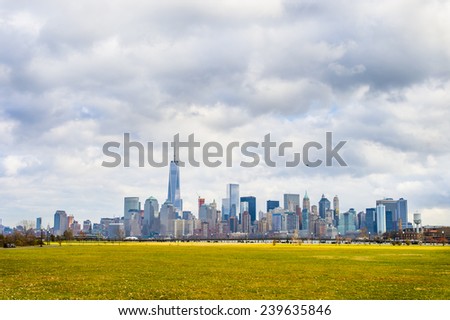 Cloudy Sky Over New York City. The Freedom Tower and Downtown Manhattan as seen from Liberty State Park, New Jersey.