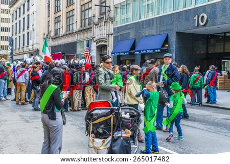 NEW YORK CITY - MARCH 17:  A family, two parents, three children, dressing in green, waiting with other people for St. Patrick\'s Day Parade on March 17, 2015 in Manhattan, New York.