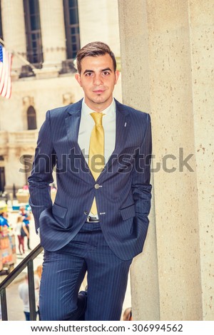 Businessman with little scar on lip - cleft lip, dressing in blue suit, yellow tie, standing outside office. Concept of facing reality, up and down, self assured, self esteem, confidence and success.