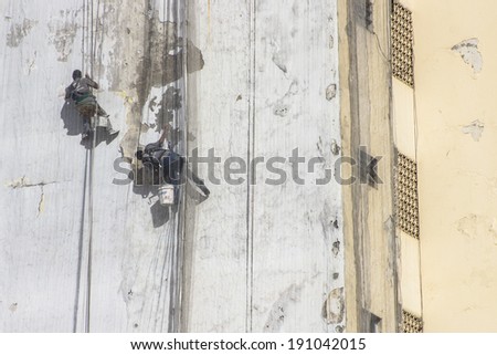 SAO PAULO, BRAZIL, APRIL 30, 2014. Building maintenance: Man working at height
