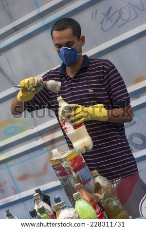 SAO PAULO, BRAZIL, OCTOBER 11, 2011: Graffiti artist works on his creation on street.