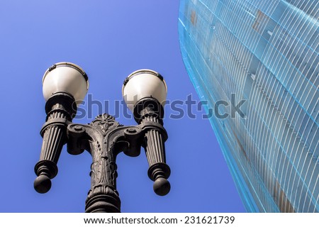 SAO PAULO, BRAZIL - NOVEMBER 18, 2014: Detail of Facade renovation of the Copan building and old pole light in downtown Sao Paulo. Copan is the largest residential building in the world.