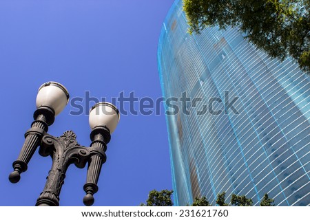 SAO PAULO, BRAZIL - NOVEMBER 18, 2014: Detail of Facade renovation of the Copan building and old pole light in downtown Sao Paulo. Copan is the largest residential building in the world.