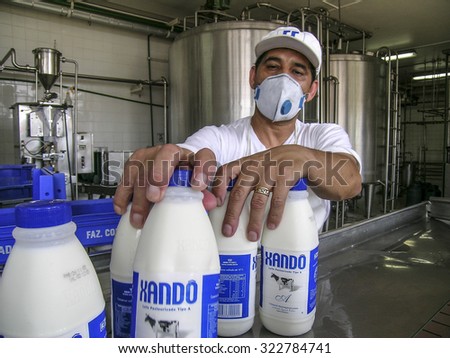 Araras, Sao Paulo, Brazil, november 25, 2003. Worker on milk products line at dairy