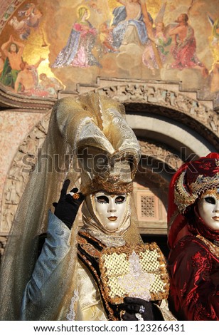 VENICE - FEBRUARY 17:  Elegant  masks with San Marco church paintings on  February 17 , 2012 in Venice , Italy . In 1979, a group of Venetians decided to revive the tradition of Carnivals
