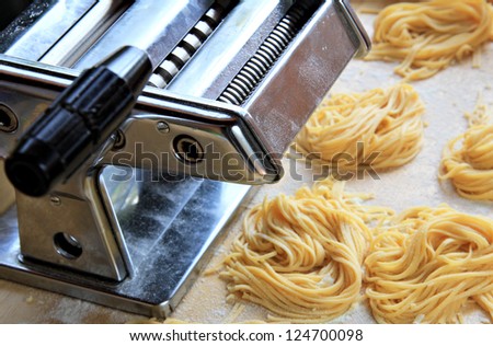 Manual pasta maker with fresh egg homemade tagliatelle . Healthy food concept