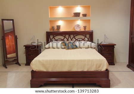 Classic bedroom with elegant wooden furniture. Warm and comfortable light