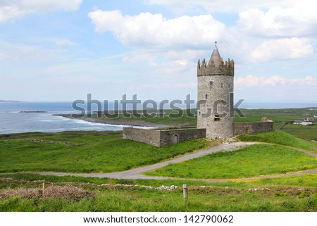 Doonagore castle , irish stone guardian between green fields and sea. Ireland