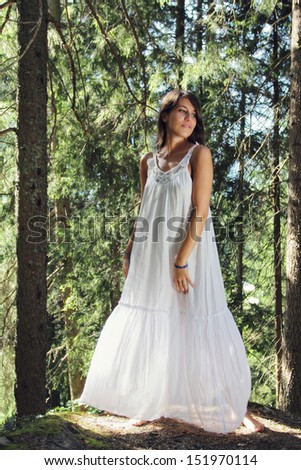 Beautiful young woman white dressed in the forest. Romantic portrait