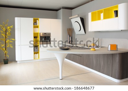 Wide visual of a modern kitchen white and yellow colored
