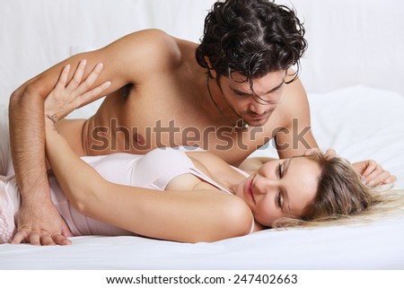Beautiful woman refusing intimacy with her man in bed . Couple problems concept