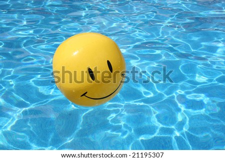 stock photo : Smiley face ball floating in swimming pool.
