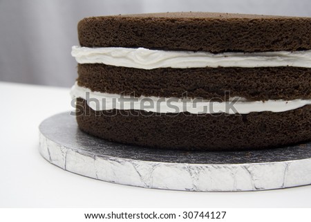 Three layer chocolate cake with vanilla frosting. Showing layers before the final frosting is applied.