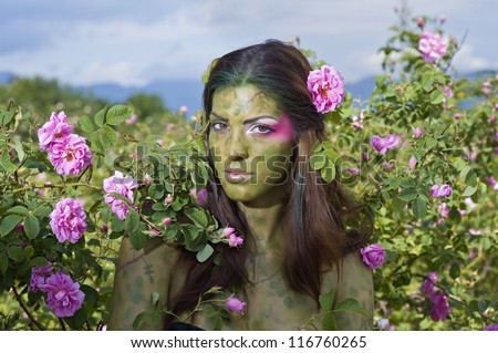 Beautiful girl standing in rose field