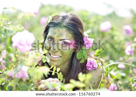 Beautiful girl in a rose field