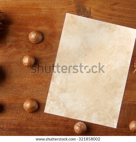 paper on teakwood board with cones araucaria almond nut with lot of copy space square format