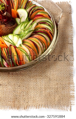 salad  cucumber Beetroot Carrot sliced cut to round pieces arranged on a on glass plate burlap cloth with more copy space
