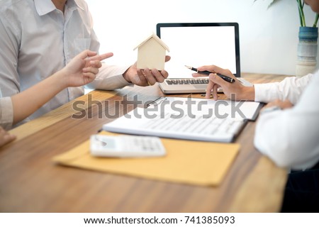 Business man agreement to sign for contract for new home buy or rent with white computer screen clipping path.