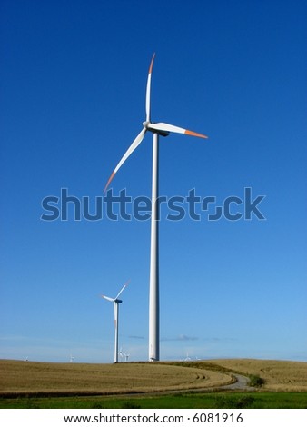 Giant wind turbines on a hilly field