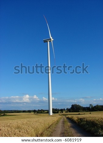 Giant wind turbine on a hilly field