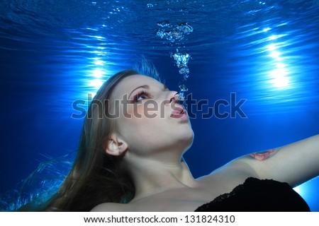 Woman make bubbles underwater