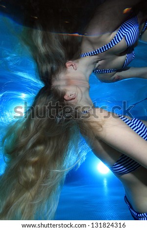 Woman underwater in the pool