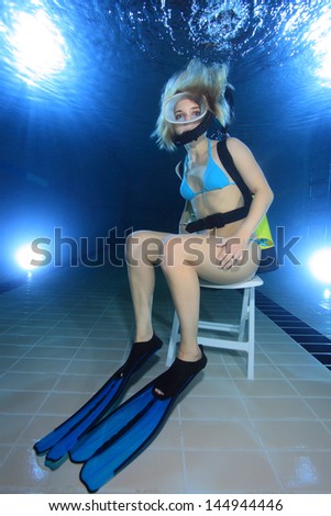 Female diver take a seat underwater