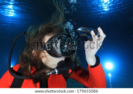 Scuba woman with diamond  and red neoprene suit underwater