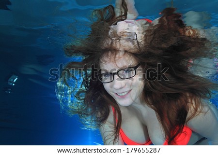Woman underwater in the pool with glasses