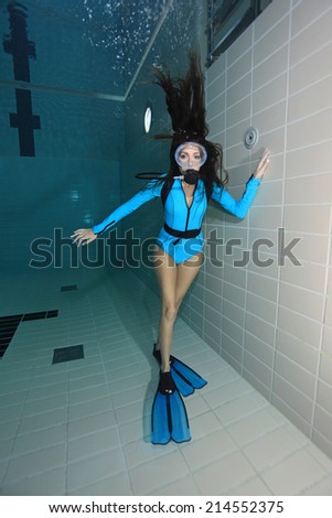 Female scuba diver with lycra suit underwater in the pool