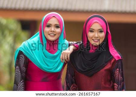 Fashion portrait of two young beautiful muslim woman wearing hijab