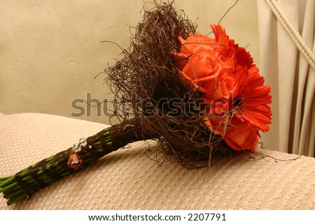 stock photo Bridal bouquet with orange roses and gerber daisies lying on 