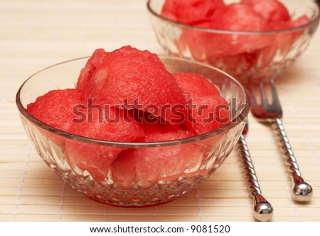 Juicy watermelon scoops in crystal bowls with silver decorative forks