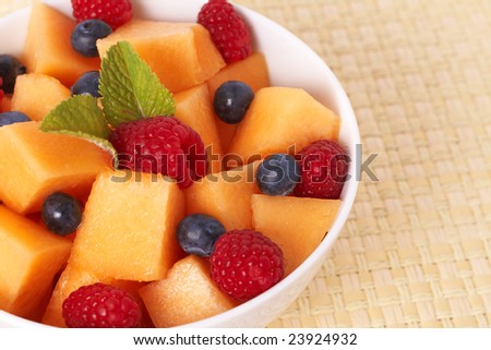 stock photo : Bowl of summer fruit salad with raspberries, melon, 