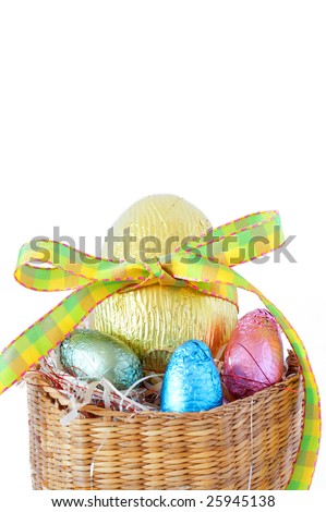 chocolate easter eggs in a basket. stock photo : Assortment of chocolate Easter eggs wrapped in colorful paper
