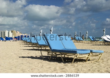 Chairs on the empty beach.