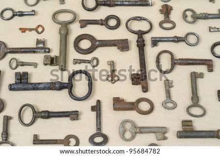 many different old keys on a lighter background fabric