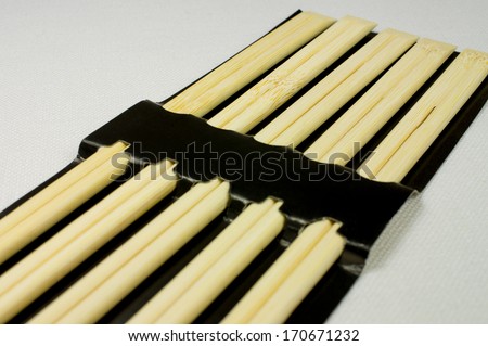Five pairs of chopsticks in a black package