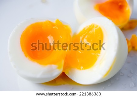 Two soft boiled eggs broken in half
