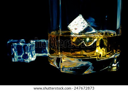 Bourbon whiskey with ice on a black background