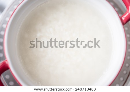 Rice in a saucepan on the stove to cook