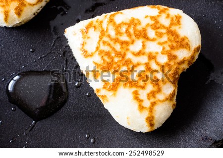 Pancakes in the form of hearts on a frying pan