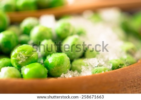 Frozen green peas with pieces of pods covered with frost