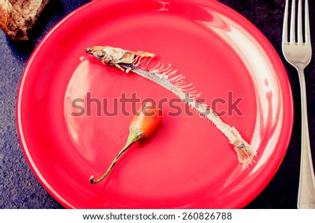 Leftovers fish skeleton and red pepper
