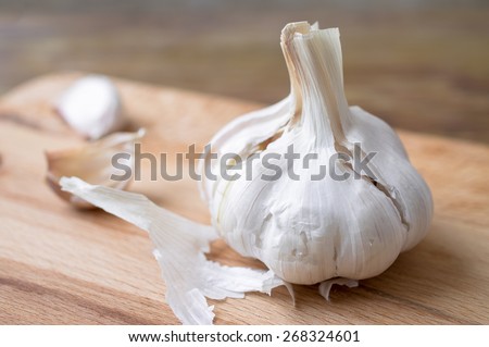 Clove garlic and garlic cloves and peel on a wooden board